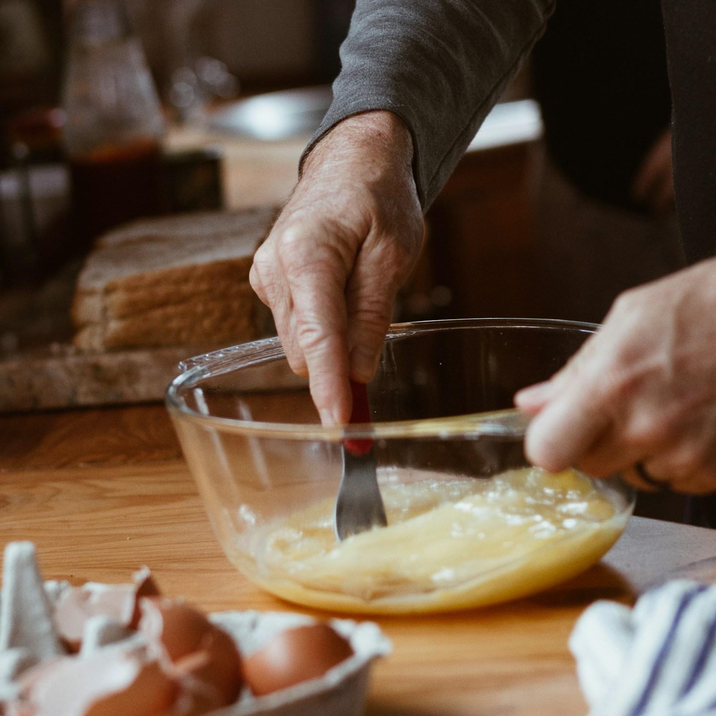 Community members collaborating in a modern kitchen space, sharing recipes and cooking techniques
